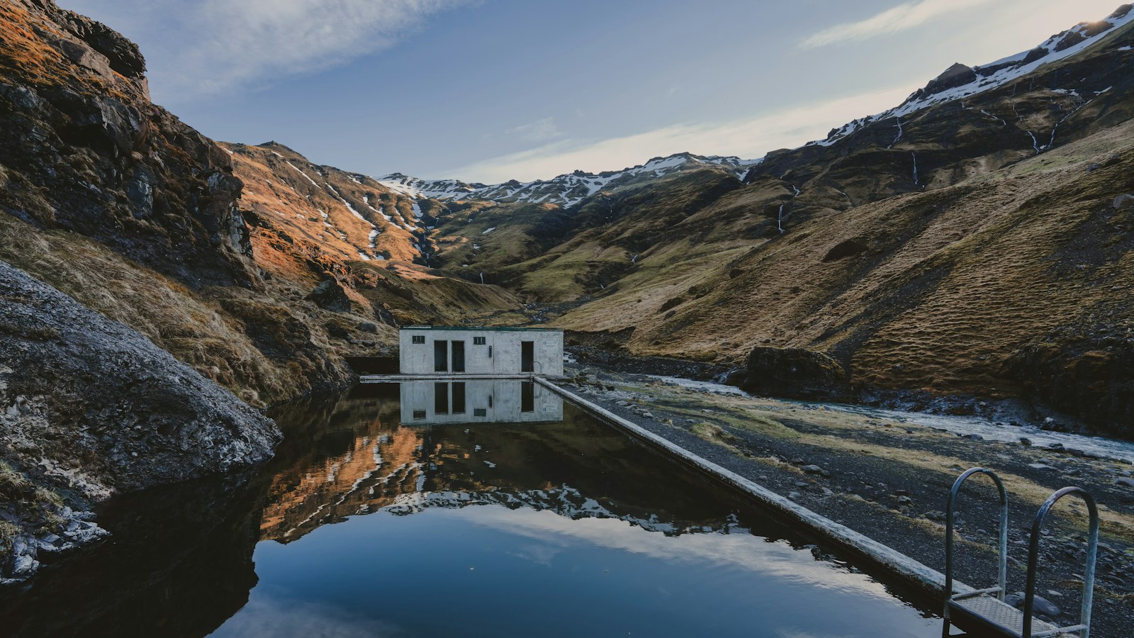 The old Seljavallalaug swimming pool set in a mountain valley