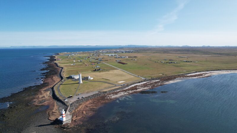 Aerial view of the coastline with two lighthouses and surrounding shoreline (Garðskagaviti)