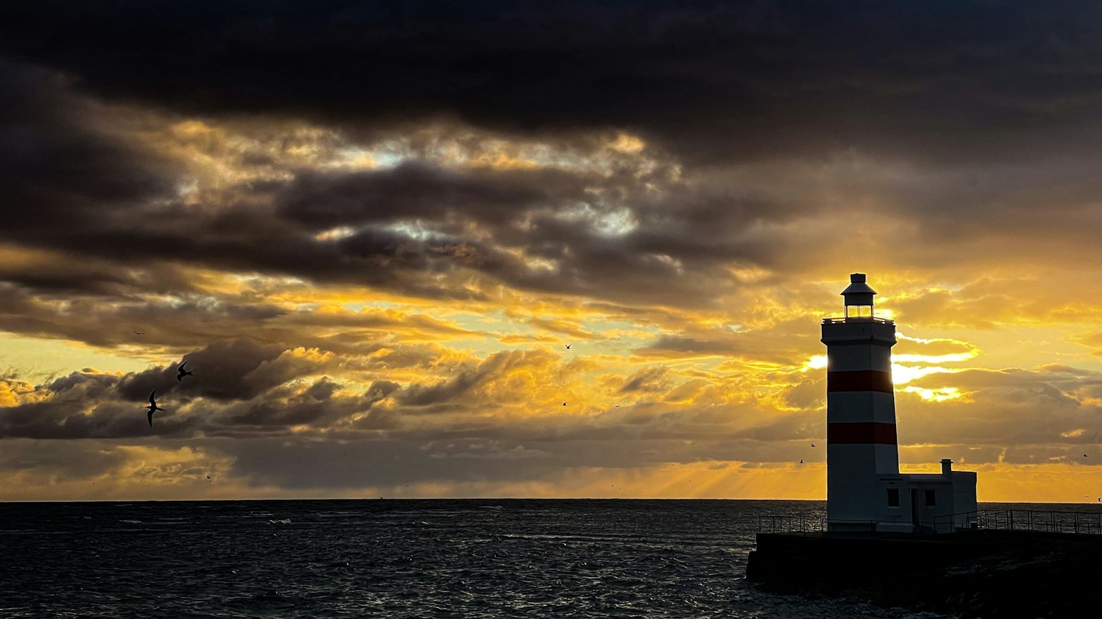 A lighthouse at sunset on the Reykjanes coast