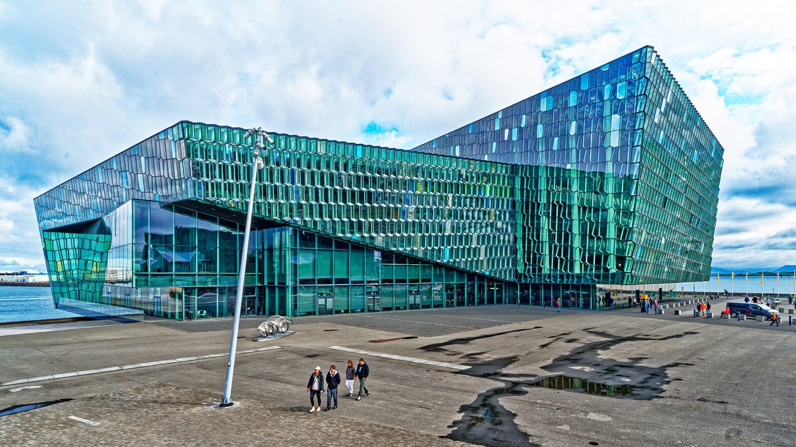 Exterior of a modern glass concert hall by the waterfront (Harpa)