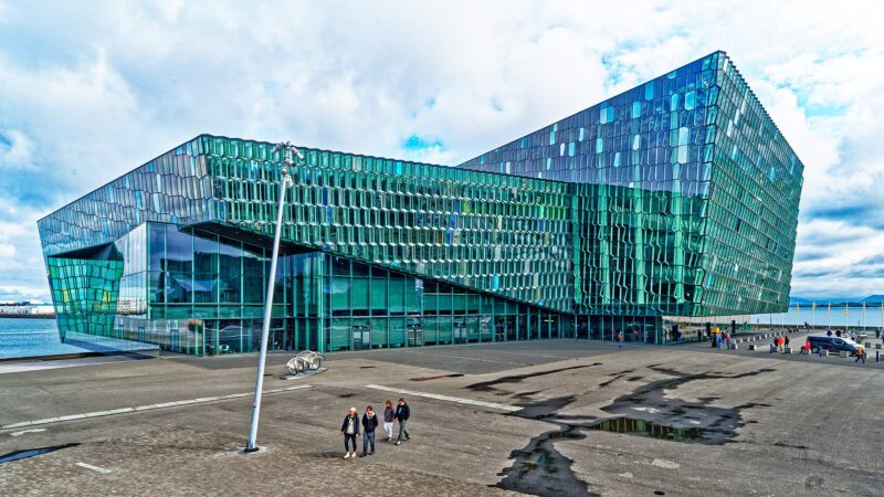 Exterior of a modern glass concert hall by the waterfront (Harpa)