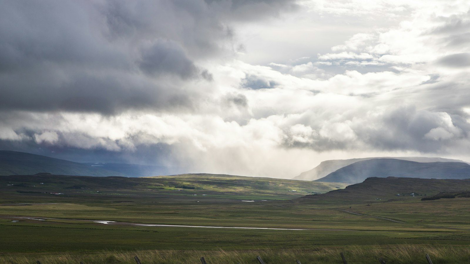 Farmland under storm clouds on Snæfellsnes