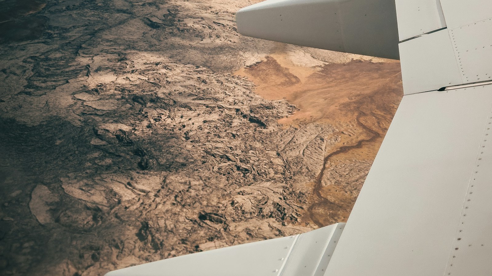 The wing of an airliner over the Icelandic landscape