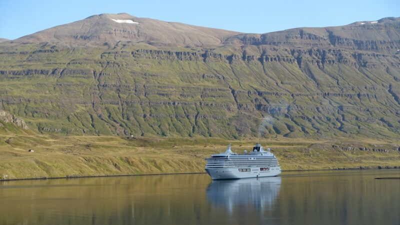 A cruise ship in a calm fjord