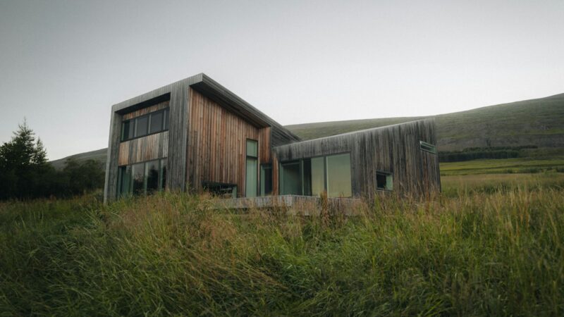A modern timber holiday cabin in a field