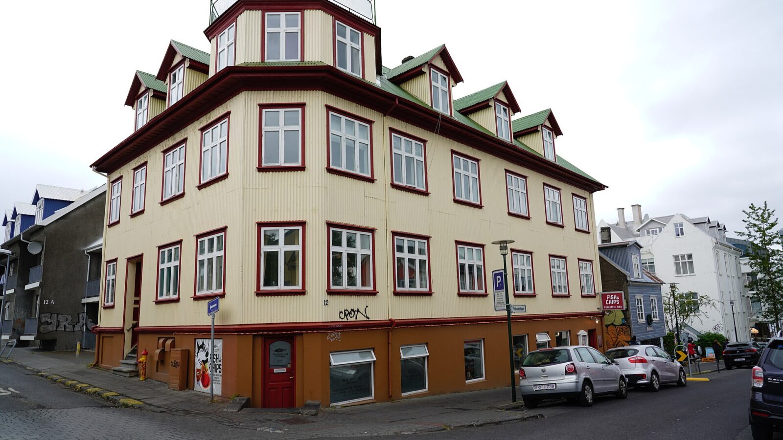 Corner of a three-storey timber building with many windows (Þjóðleikhús (National Theatre), Reykjavík)