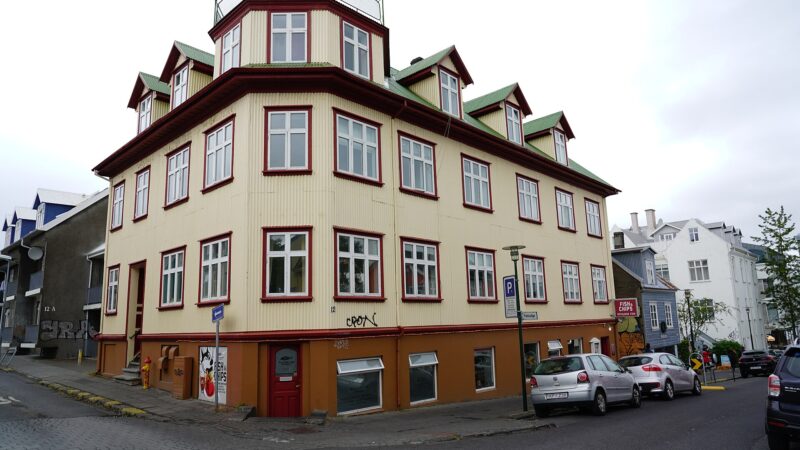 Corner of a three-storey timber building with many windows (Þjóðleikhús (National Theatre), Reykjavík)