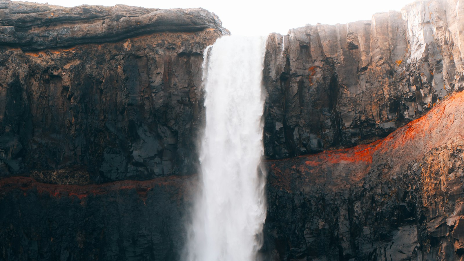 A waterfall plunging between steep rocky cliffs
