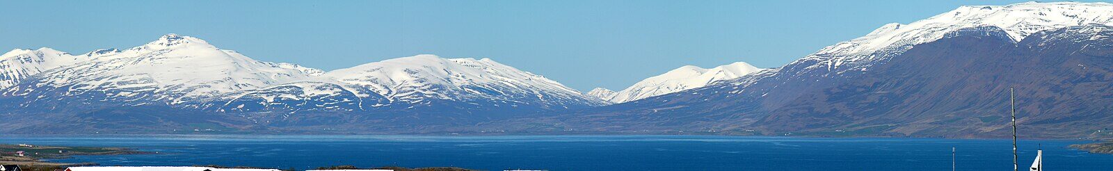 Snow-capped mountains above a coastal fjord (Akureyri)