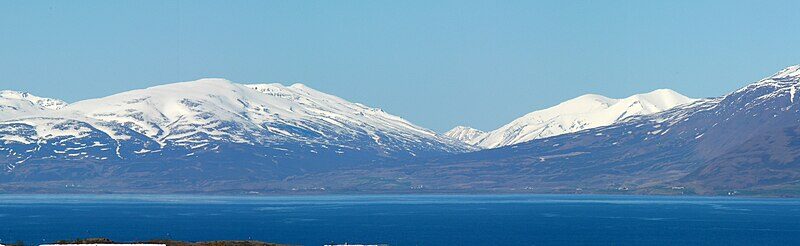 Snow-capped mountains above a coastal fjord (Akureyri)