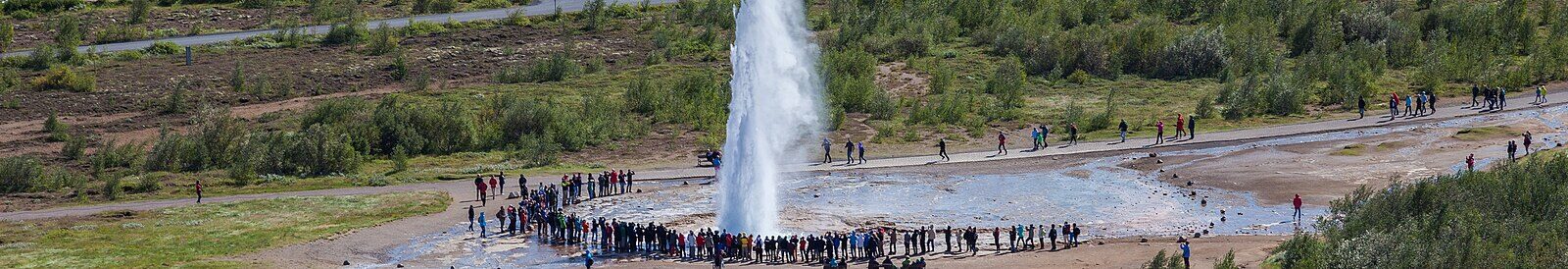 Geyser eruption with a ring of spectators around it (Bláskógabyggð)