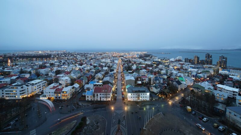 Wide dusk view over residential streets toward the harbour
