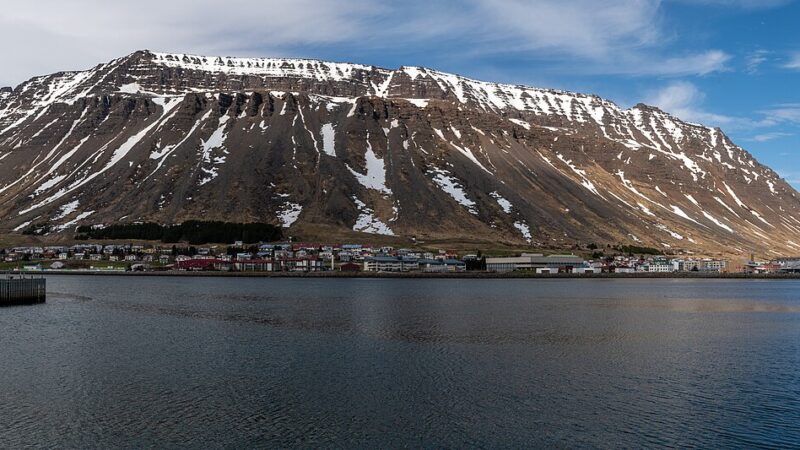 Harbour with moored yachts and a large mountain backdrop
