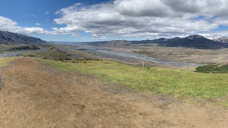 Panorama over glacial river and mountains with a viewpoint marker (Langadal, Þórsmörk)