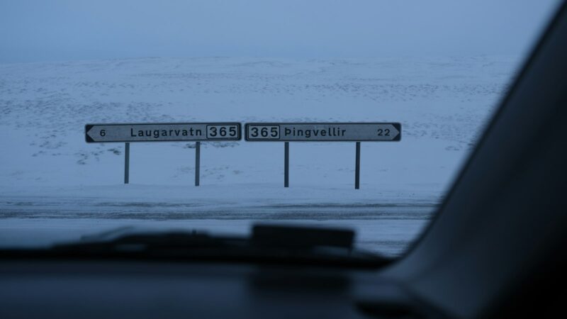 Road signs seen through a windscreen in snowy landscape