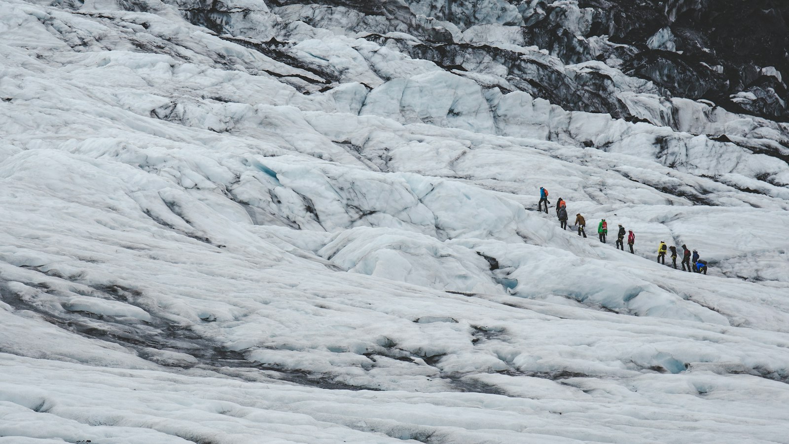 Hikers in the distance on a glacier