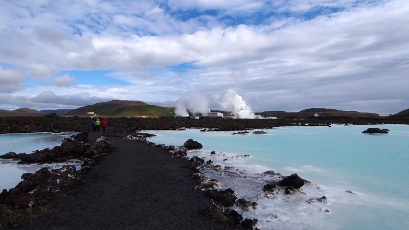Path along milky-blue geothermal pools with steam plumes (Reykjanes)
