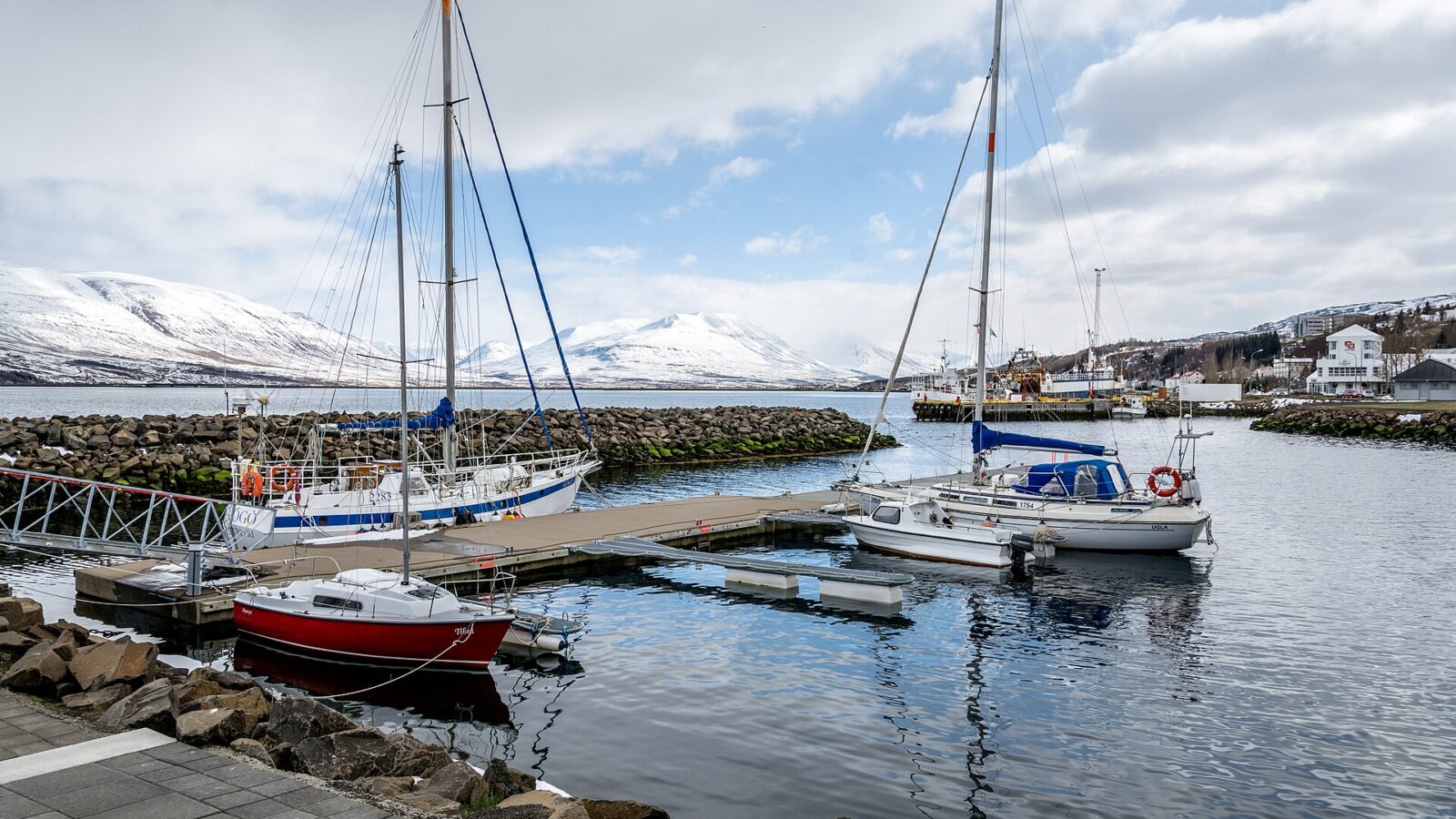 Small yachts moored at a marina with snowy mountains (Akureyri)