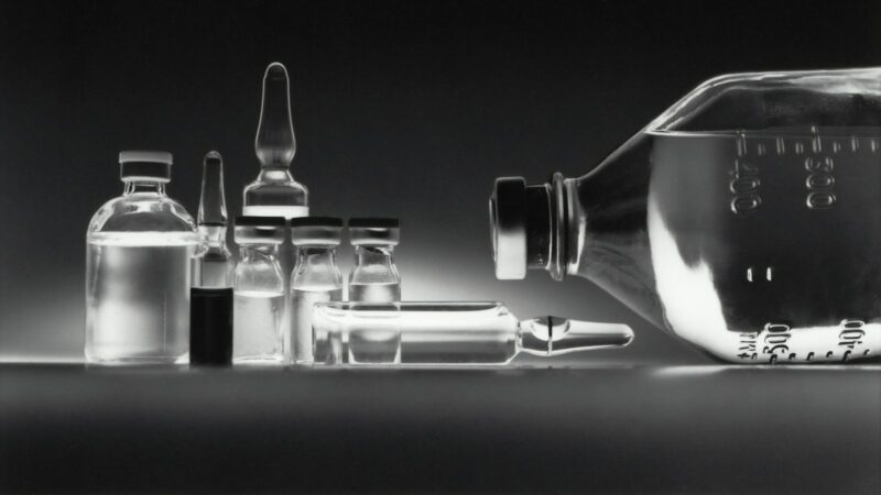 Glass medicine vials and ampoules on a surface