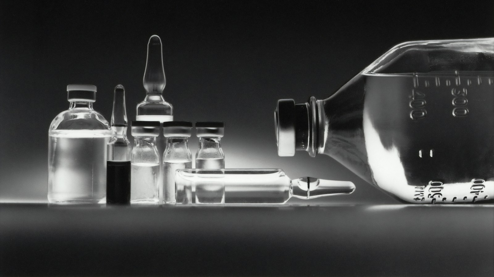 Glass medicine vials and ampoules on a surface
