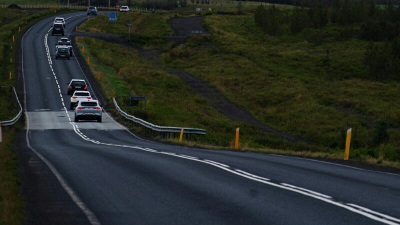 Traffic on a Reykjavík road in winter with Esja behind