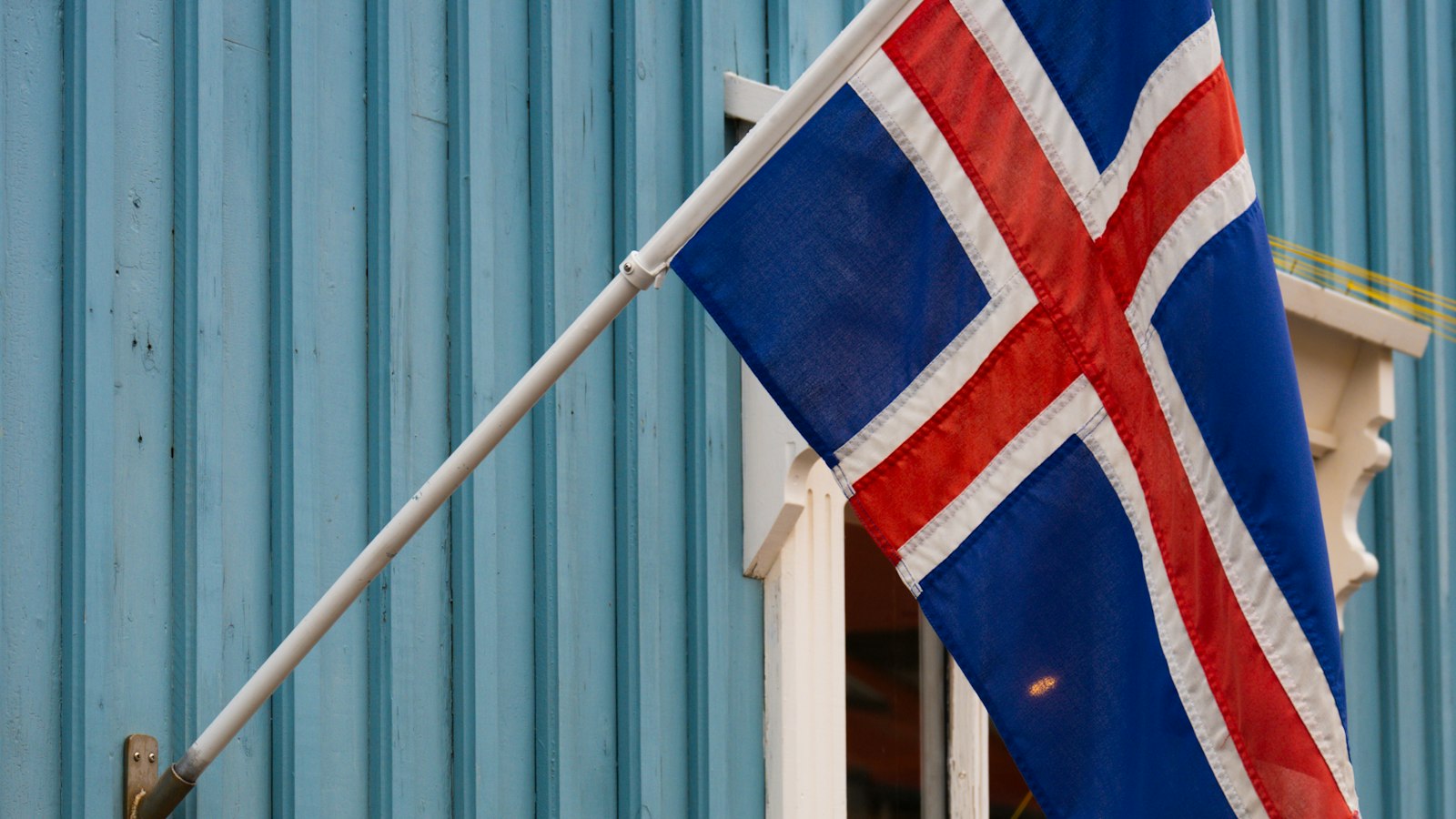 A national flag hanging from a timber house