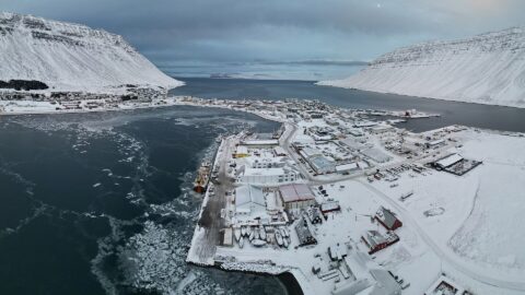 Aerial view of the harbour, quay and town covered in snow (Ísafjörður)