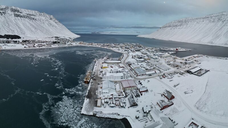 Aerial view of the harbour, quay and town covered in snow (Ísafjörður)
