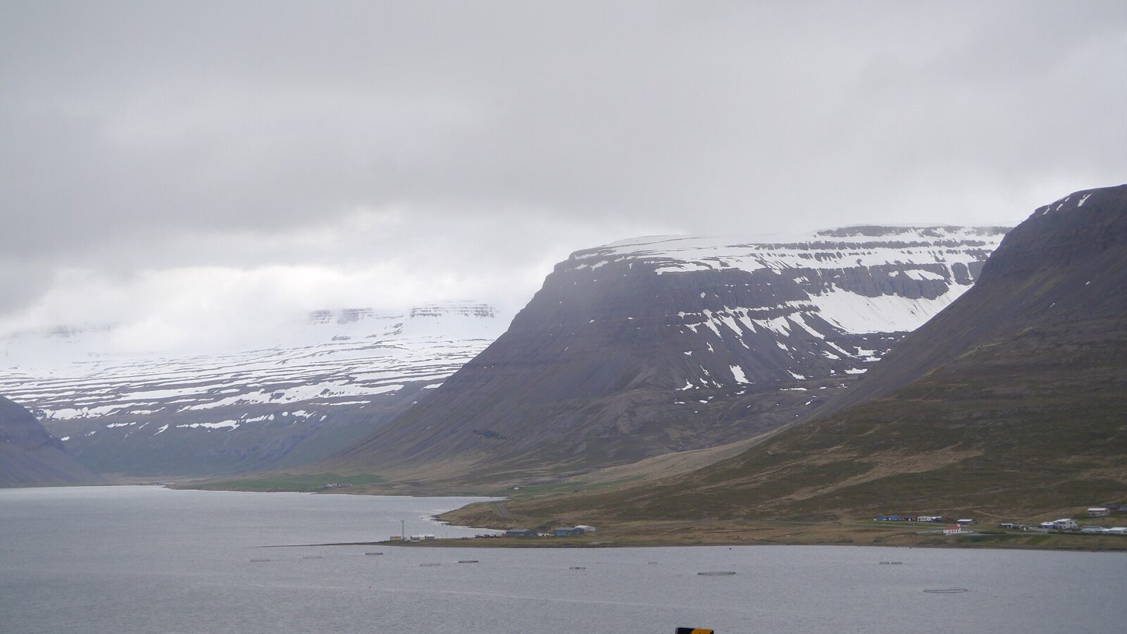 Coastal fjord with steep mountains and a narrow shoreline