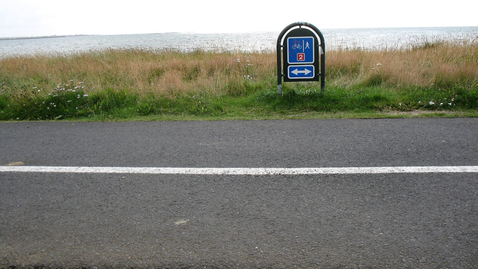Sign indicating a segregated cycle and pedestrian path by the coast