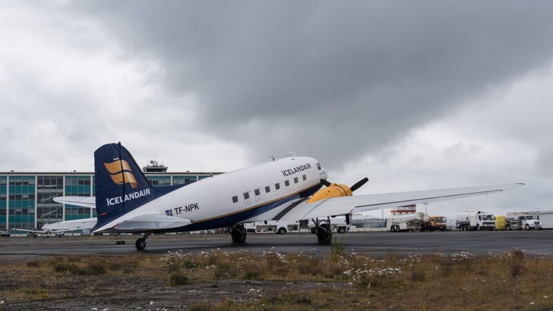 Icelandair DC‑3 parked with terminal behind