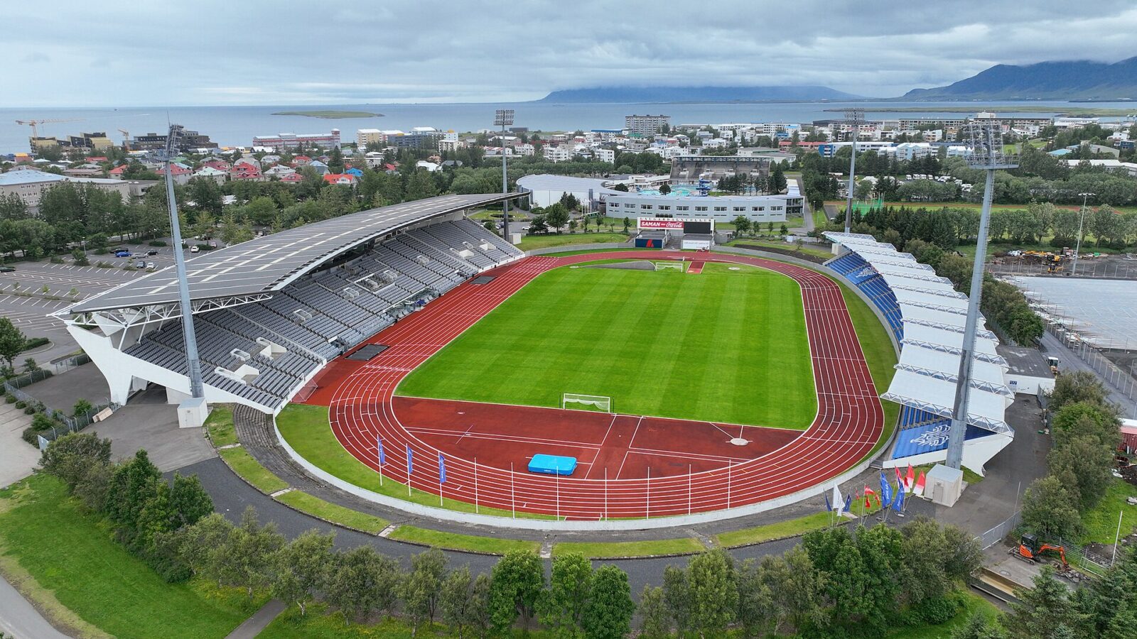 A large outdoor stadium with running track and stands (Laugardalshöll)