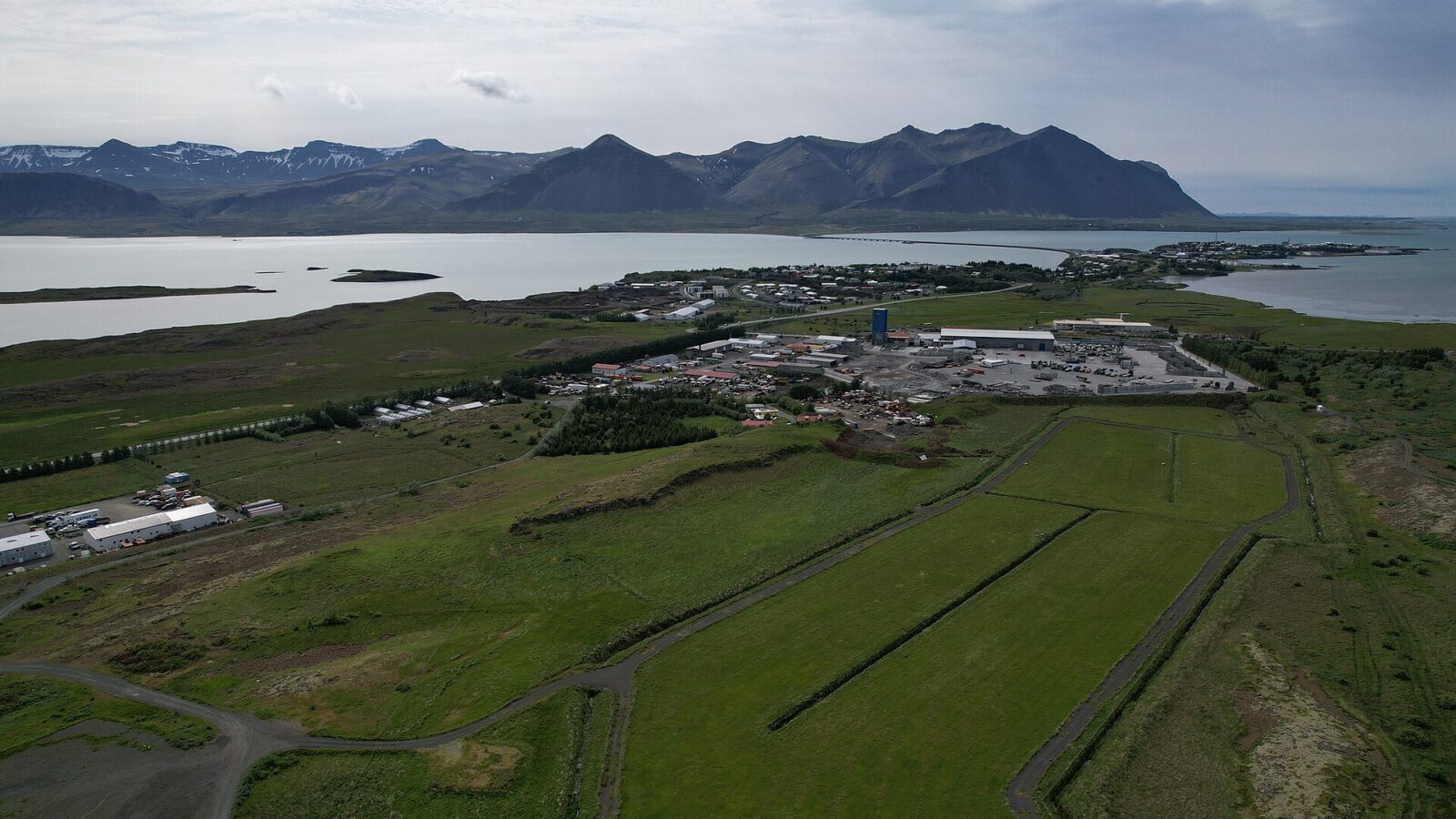 Aerial view of a coastal town with mountains behind (Borgarnes)