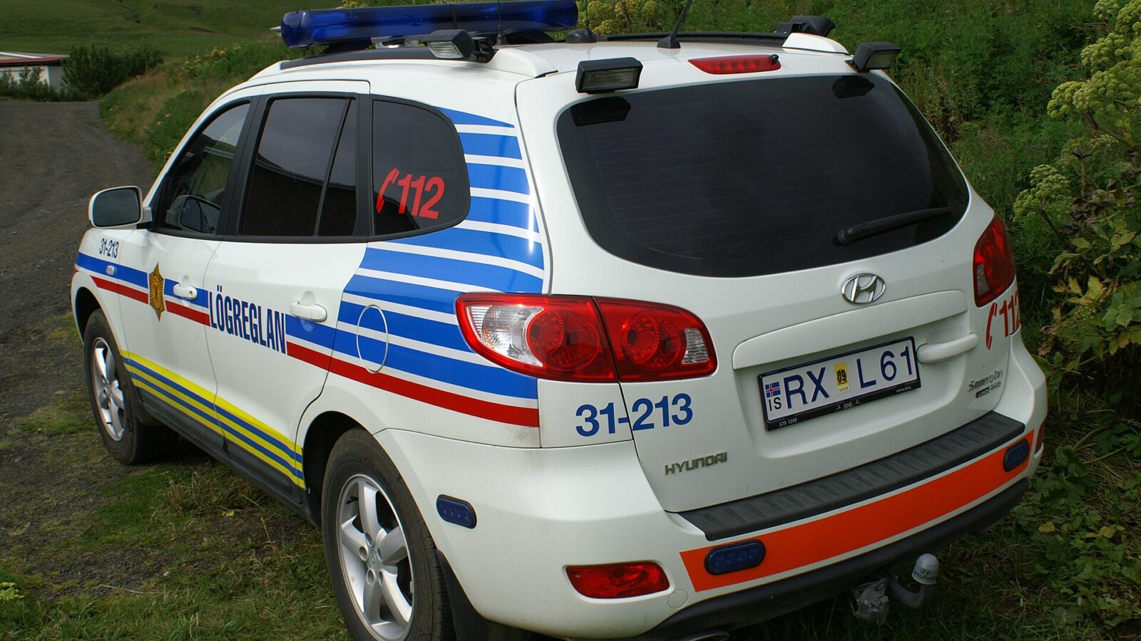 Rear and side of an Icelandic police SUV with markings