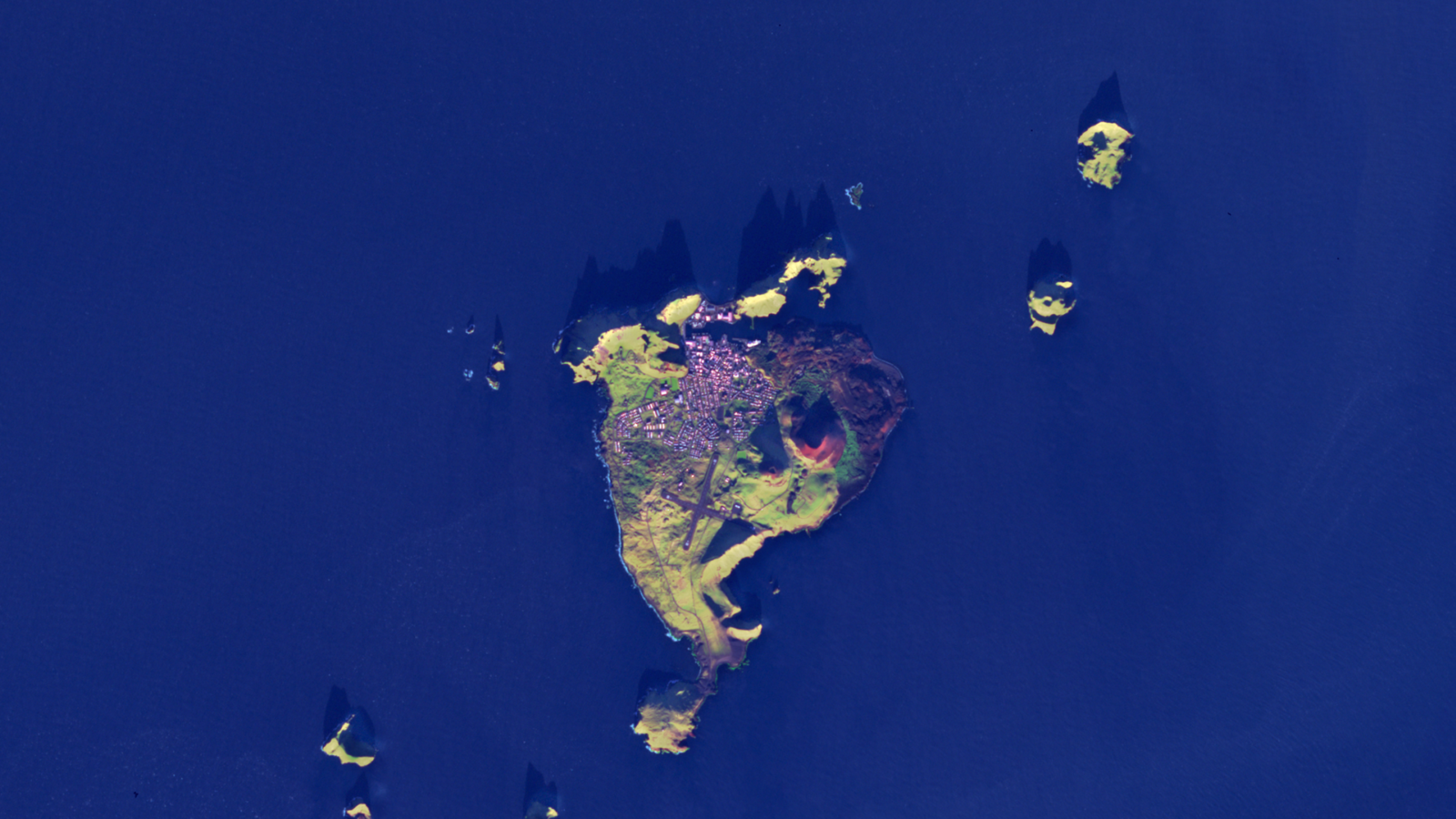 Aerial view of an island with town and cliffs (Vestmannaeyjar)