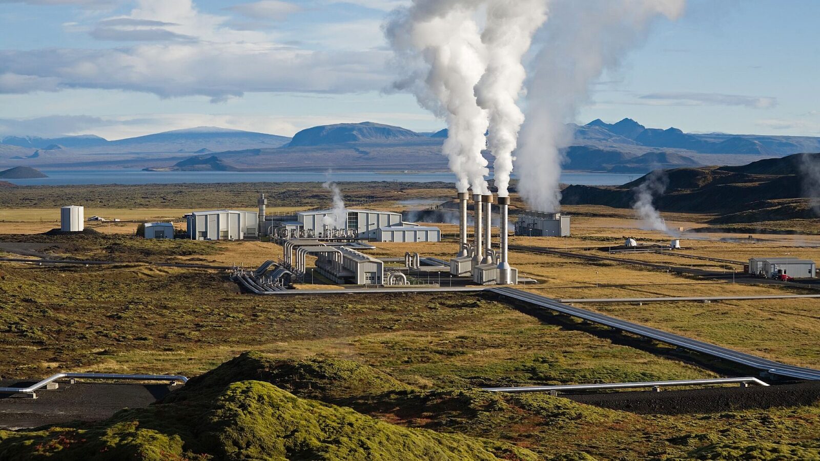 Geothermal power plant with steam stacks and pipelines