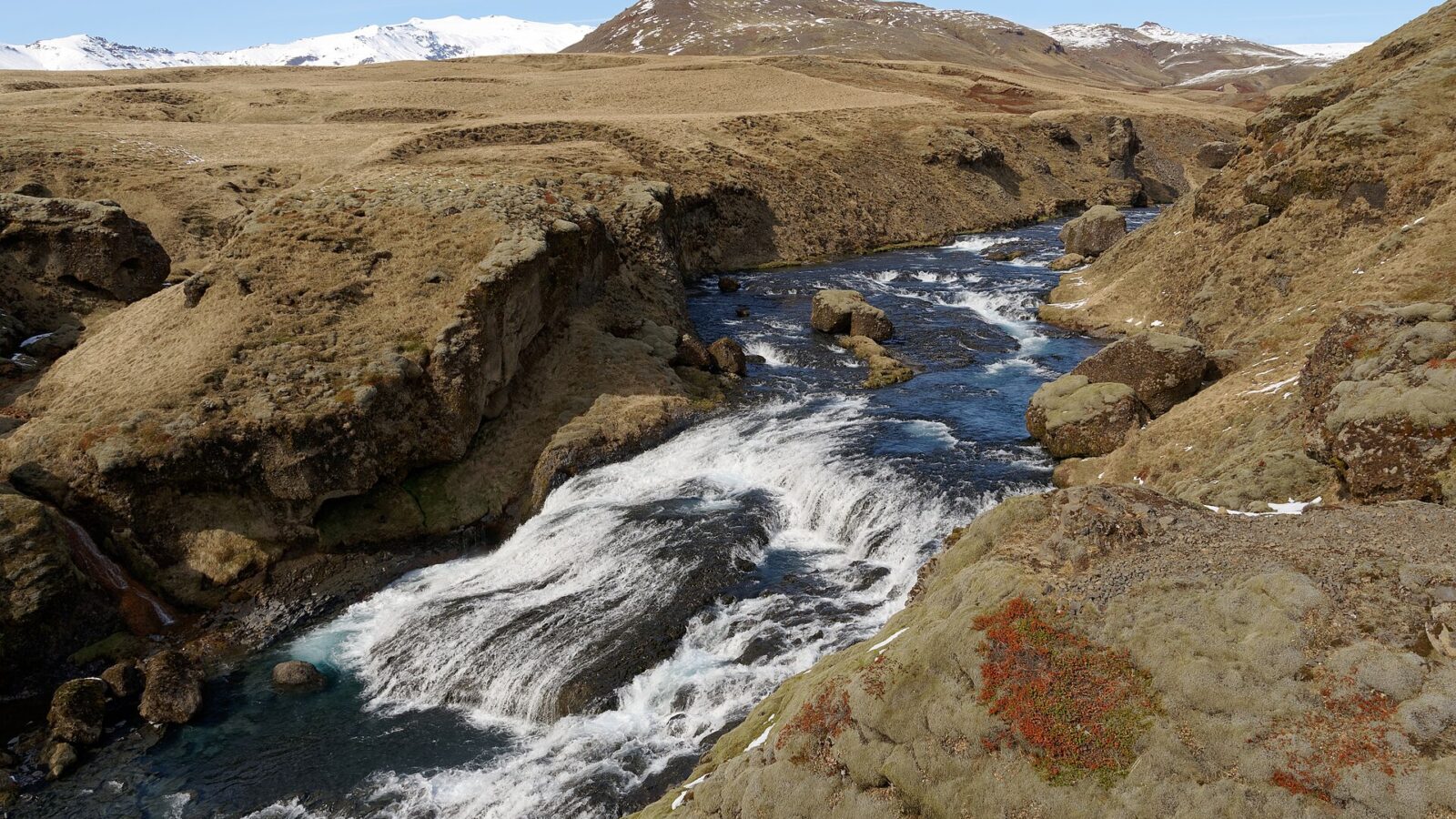 Stream cascading over rocks through a narrow valley and small falls