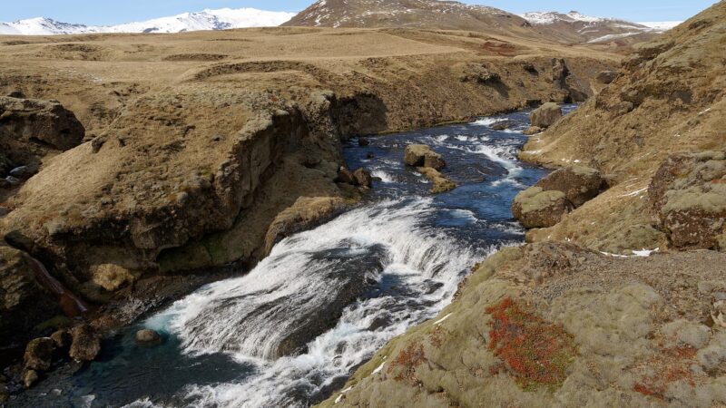 Stream cascading over rocks through a narrow valley and small falls