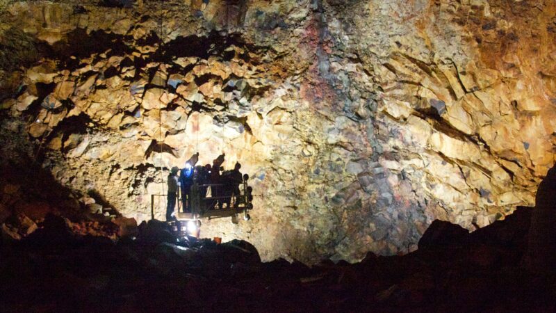 Visitors on a platform inside a volcanic crater