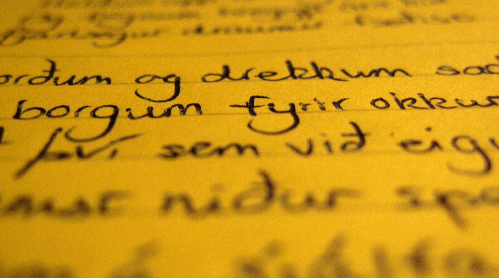 Close-up of handwritten Icelandic notes on yellow paper