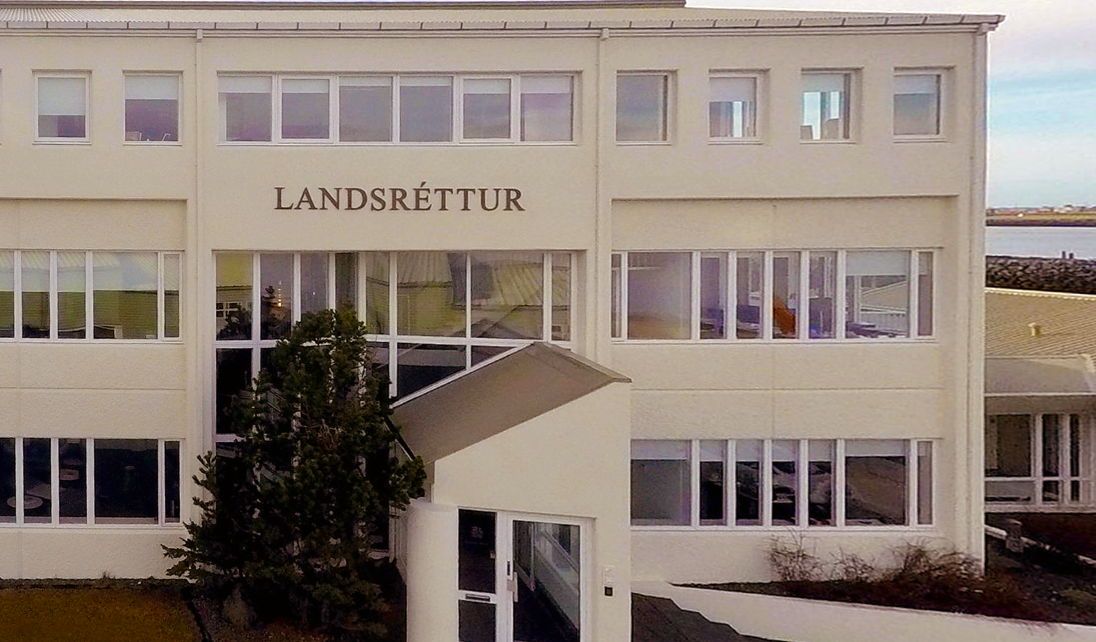 Front facade of a courthouse building with windows and entrance