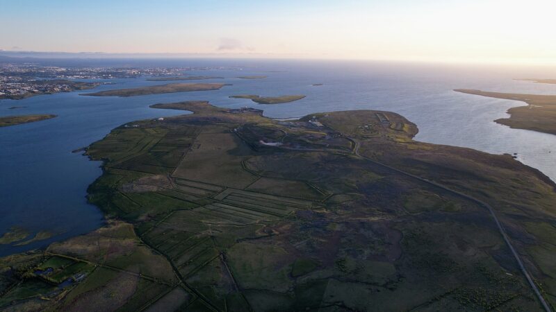 Aerial view of coastal headland and nearby town (Grafarvogur)