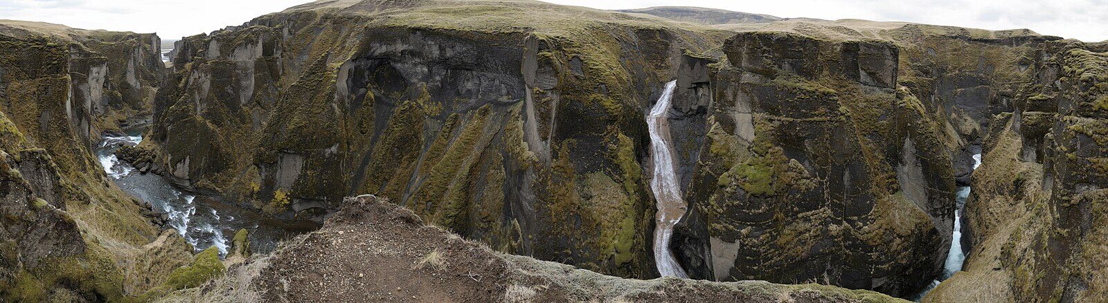 a large destination hotel exterior under construction near a canyon (Fjaðrárgljúfur)