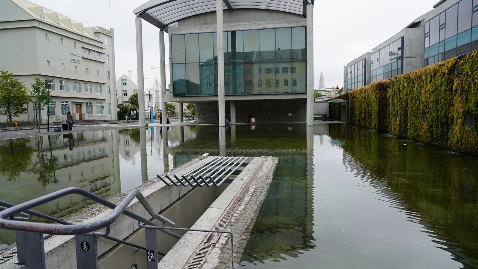 Front of a modern civic building with reflective pool (Reykjavík)