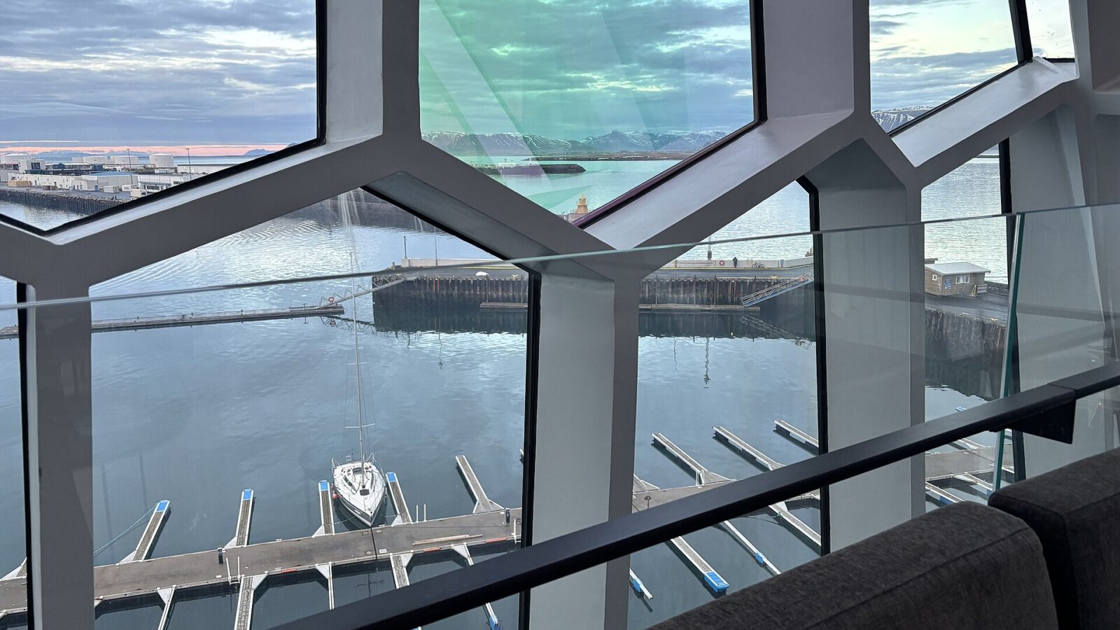 Harbour and marina seen through geometric glass windows (Harpa (Reykjavík))