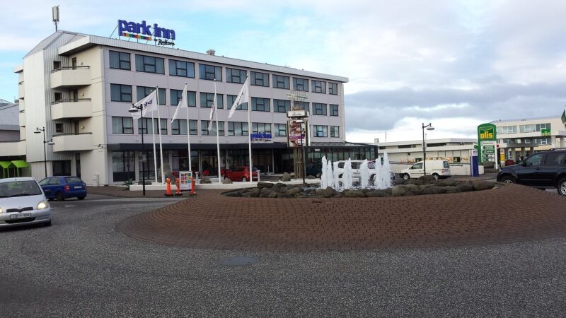 Park Inn hotel facade with fountain and roundabout in front (Keflavík)