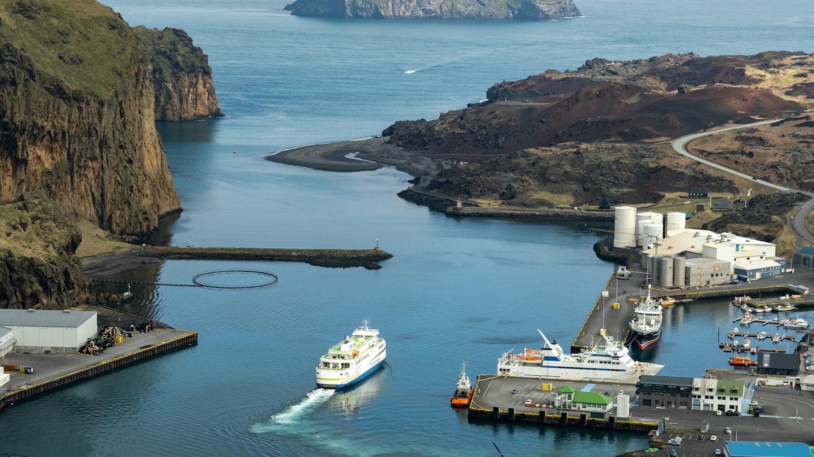 Heimaey harbour in Vestmannaeyjar with the ferry arriving between the cliffs