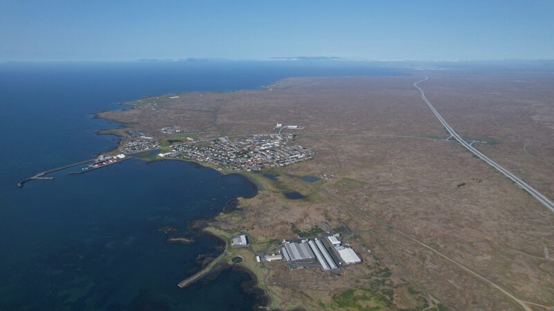 Harbour and industrial buildings with the town and coast beyond (Vogar)