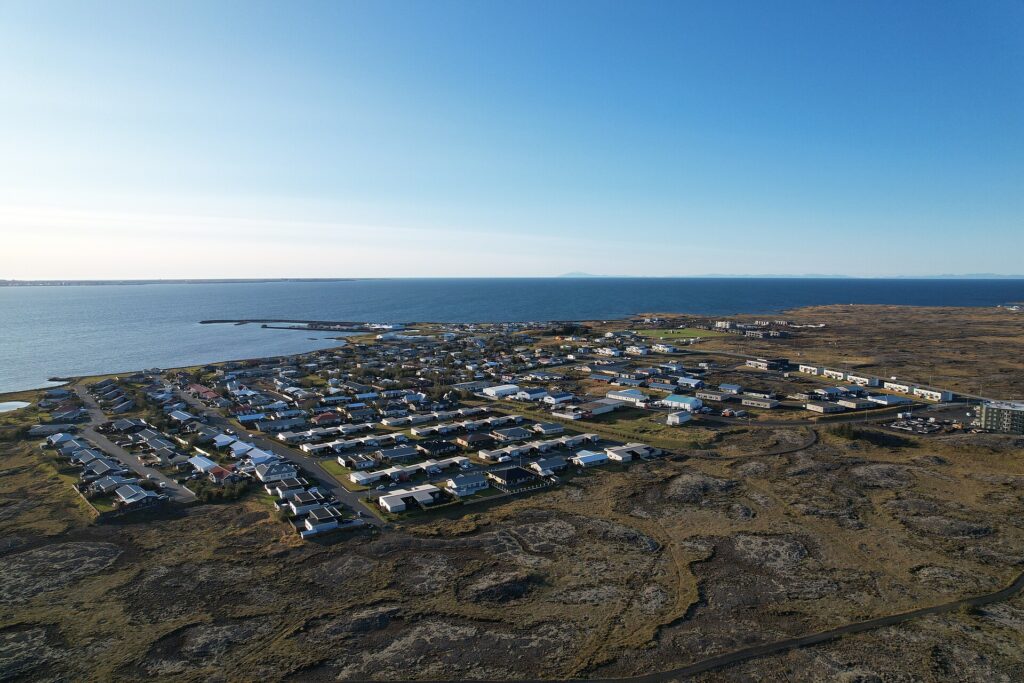 Coastal town with houses and a small harbour (Vogar)