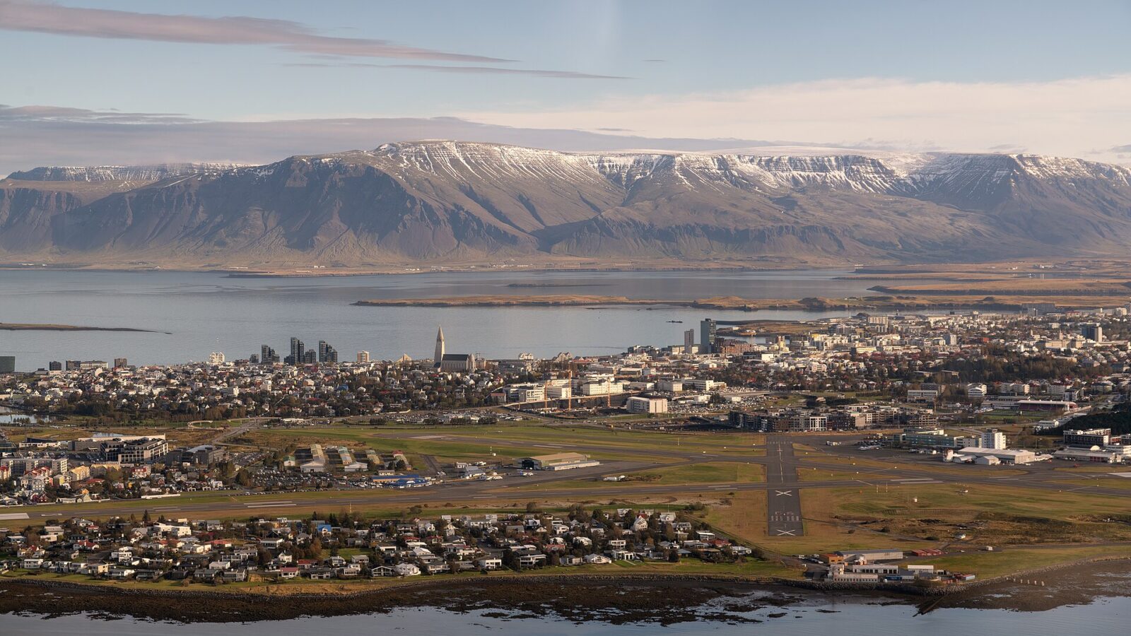 City and coastline with mountains across the bay (Álftanes)